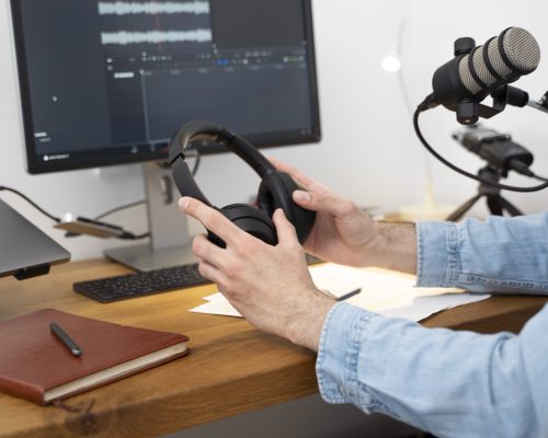 man-holding-headphones-getting-ready-podcast